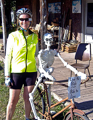 Woman with a skeleton on a bike