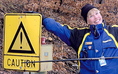 Sue Williams with Skiing Caution sign